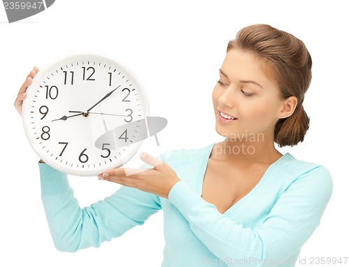 Image of woman with wall clock