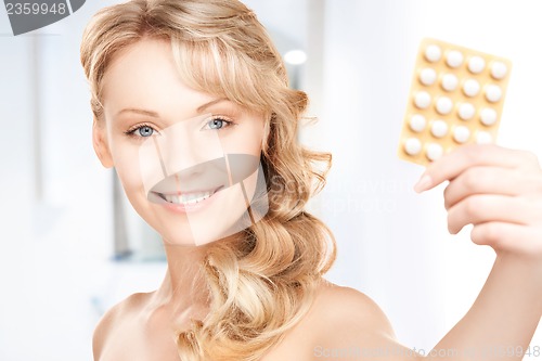 Image of young woman with pills