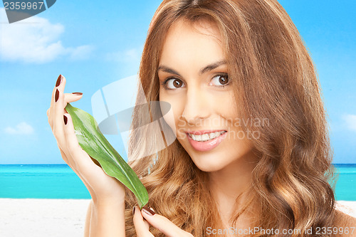 Image of woman with green leaf