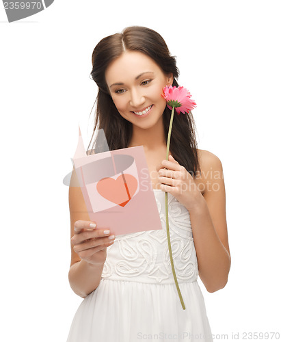 Image of young woman holding flower and postcard