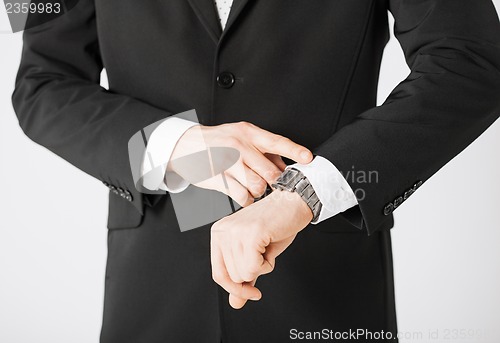 Image of man looking at wristwatch