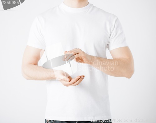 Image of mans hands showing something