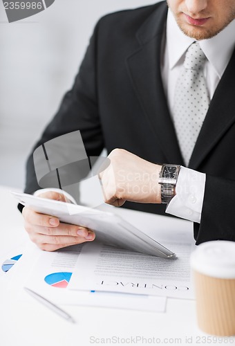 Image of man with tablet pc and cup of coffee