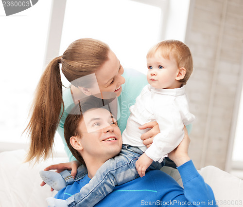 Image of happy parents playing with adorable baby