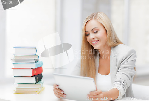 Image of student with books and tablet pc