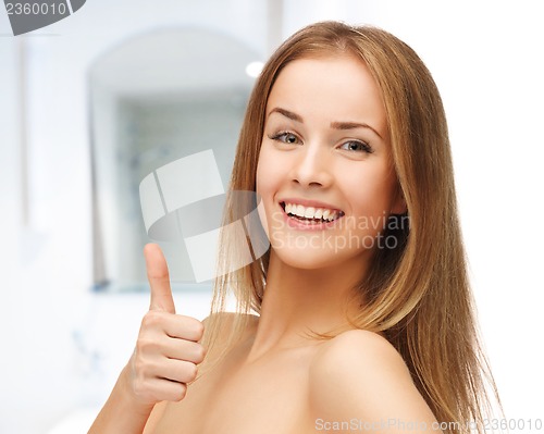 Image of beautiful woman showing thumbs up