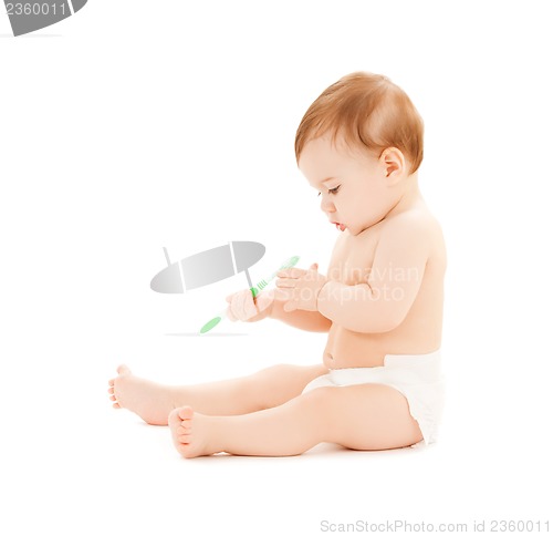 Image of curious baby brushing teeth