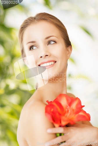 Image of beautiful woman with red lily flower