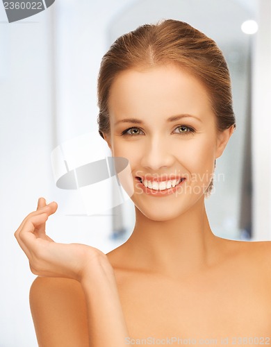 Image of beautiful woman with moisturizing creme drop