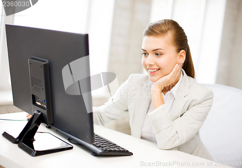 Image of businesswoman with computer in office