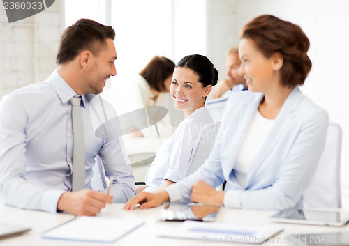 Image of business team discussing something in office