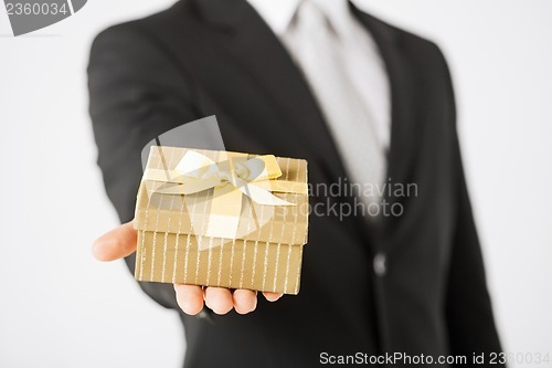 Image of man hands holding gift box