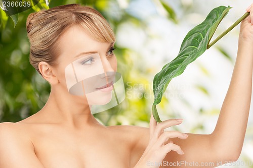 Image of woman with green leaf