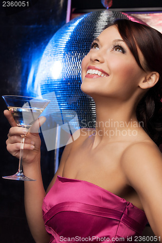 Image of woman with cocktail and disco ball