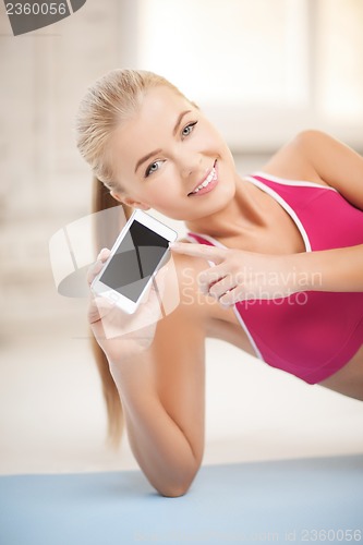 Image of woman lying on the floor with smartphone