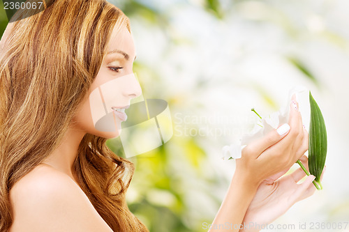 Image of lovely woman with lily flower