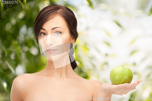 Image of young beautiful woman with green apple