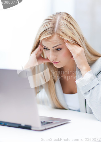 Image of stressed woman with laptop