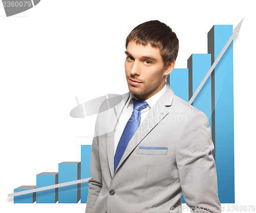 Image of handsome businessman with big 3d chart