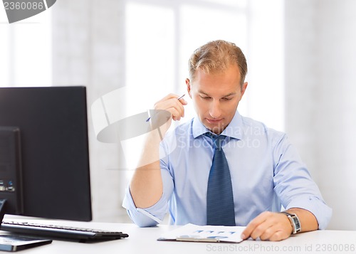 Image of businessman writing in notebook