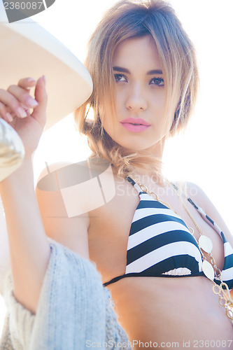 Image of fashion model posing on the beach