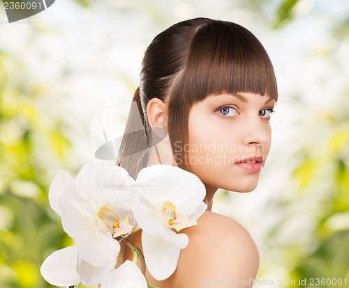 Image of beautiful woman with orchid flower