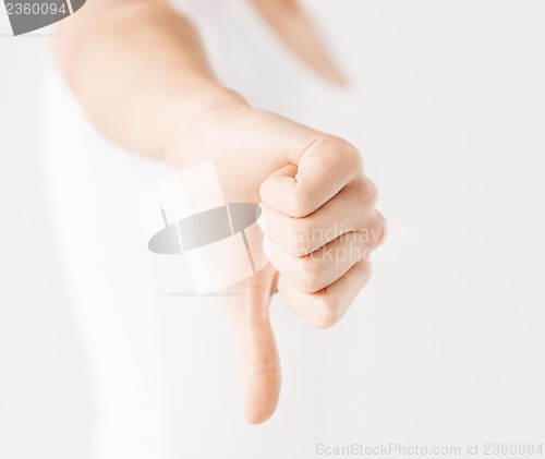 Image of woman showing thumbs down