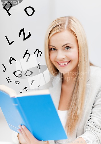 Image of young woman reading book