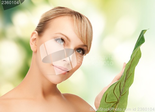 Image of woman with green leaf