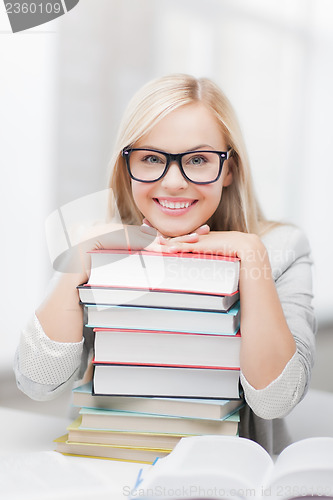 Image of student with stack of books