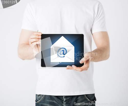 Image of man holding tablet pc with email sign