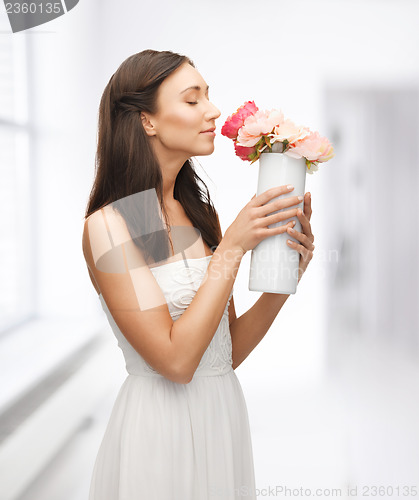 Image of woman with vase of flowers