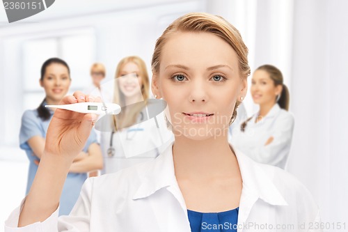 Image of attractive female doctor with thermometer