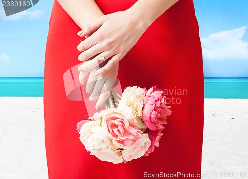 Image of woman hands with flowers and ring