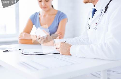 Image of patient and doctor prescribing medication