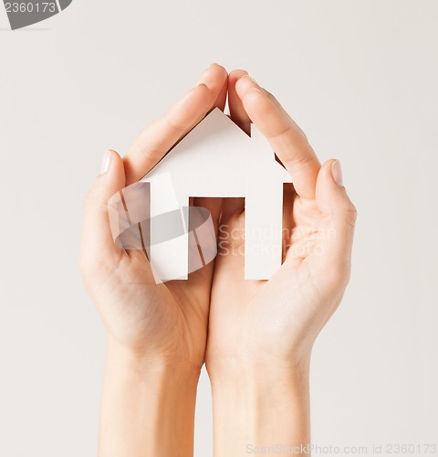 Image of woman hands with paper house