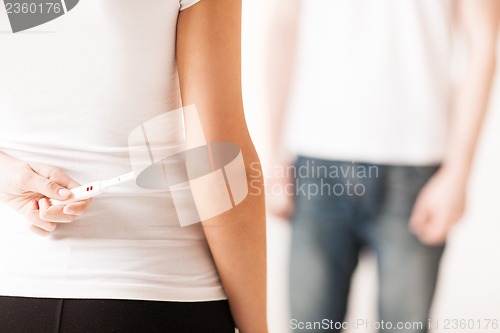 Image of woman hiding pregnancy test