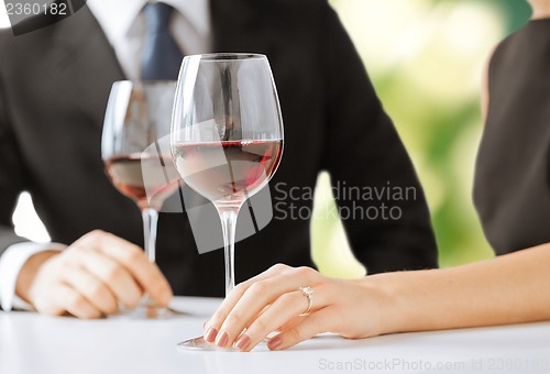 Image of engaged couple with wine glasses