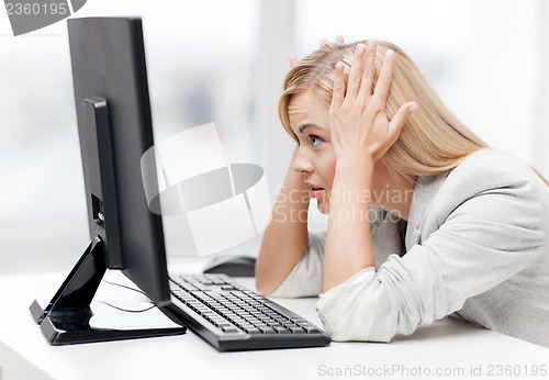 Image of stressed woman with computer