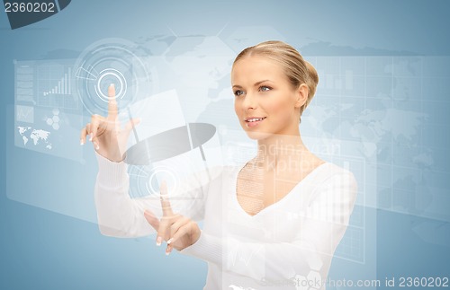 Image of businesswoman touching virtual screen