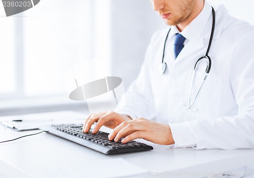 Image of male doctor typing  on the keyboard