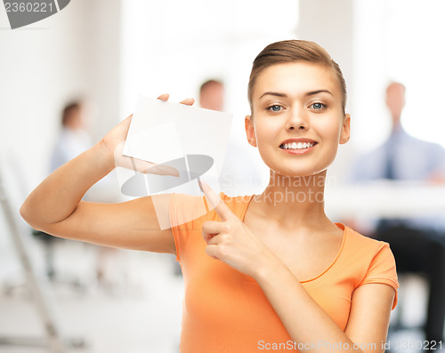 Image of woman pointing at white blank card in office