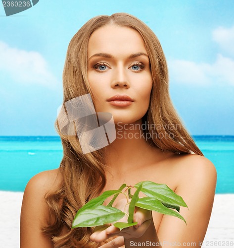 Image of woman with green leaf