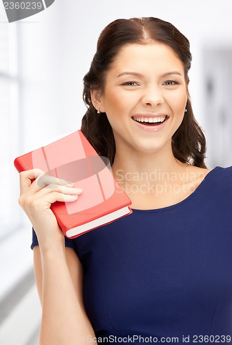 Image of happy and smiling woman with book