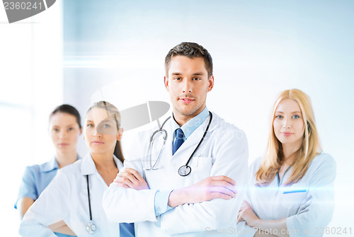 Image of male doctor in front of medical group