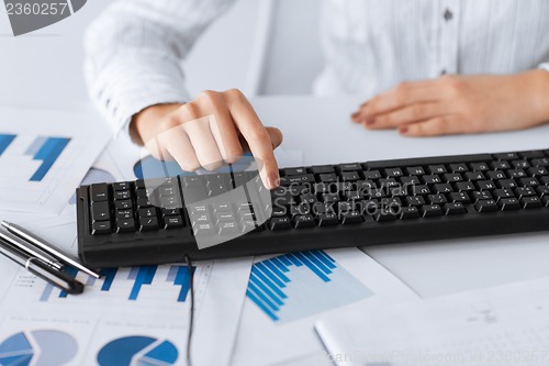 Image of woman hand pressing enter button on keyboard