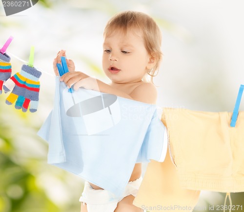 Image of baby doing laundry