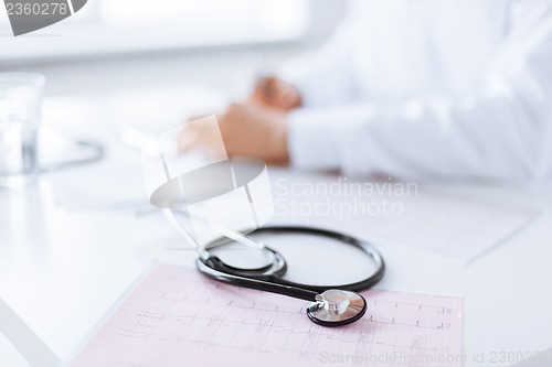 Image of male doctor hands with cardiogram