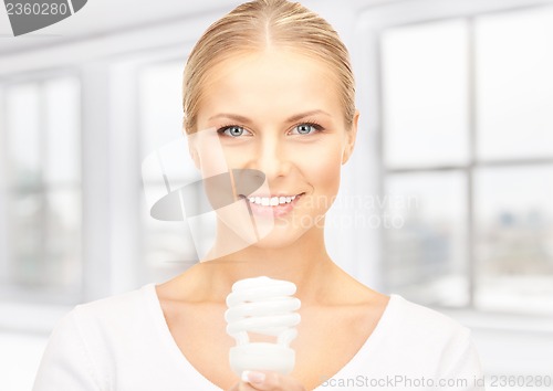 Image of woman holding energy saving bulb