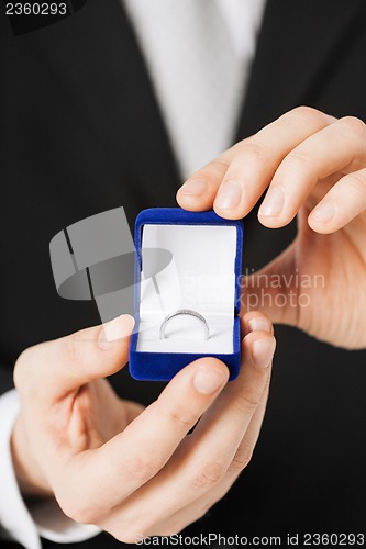 Image of man with gift box and wedding ring